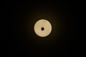 light fixture looks like moon against black background