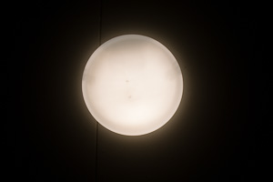 light fixture looks like moon against black background