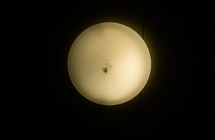 light fixture looks like moon against black background