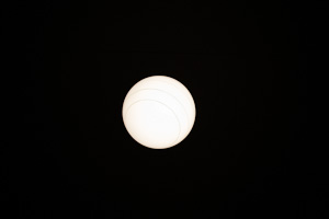 light fixture looks like moon against black background